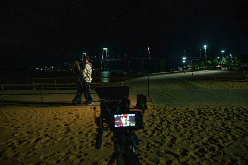 Rodaje nocturno de videoclip en la costanera con el puente de fondo